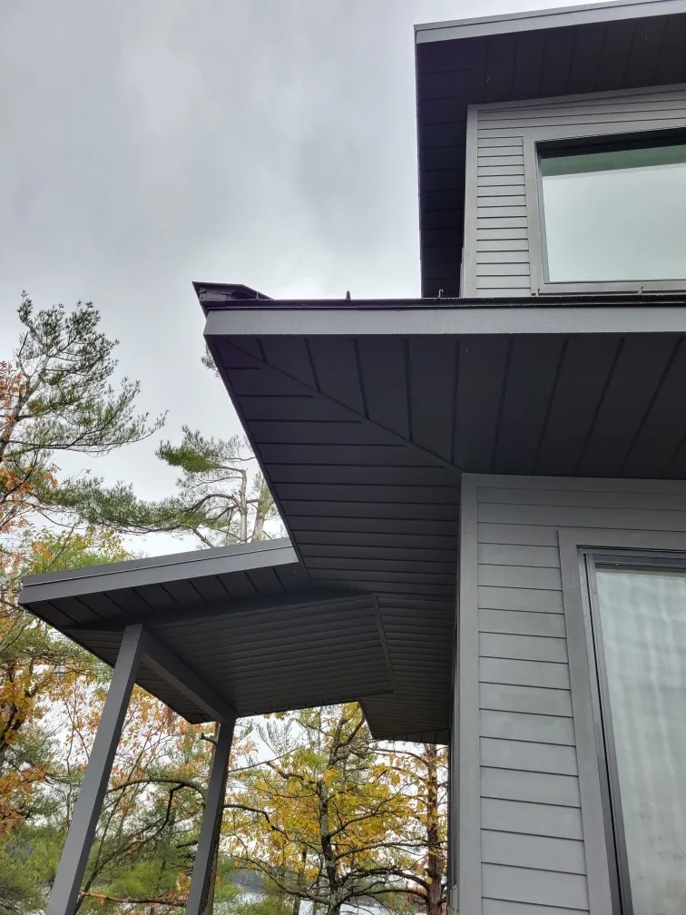 Dark metal soffit panels meeting neatly at the corner of a roof overhang